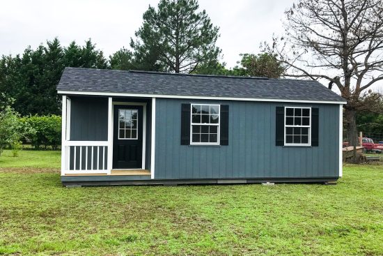 Wood sheds in Georgia with two windows, and one black door with window insert.