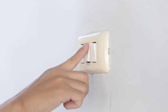 Sheds in Georgia - Fair-skinned hand activating light switch