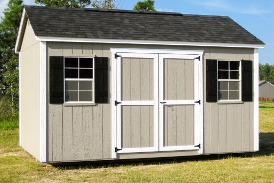 One of our beige Garden Max sheds in Griffin GA - Beige siding with white-trimmed double doors white windows with black shutters beneath black shingled roof