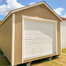 Buckskin and white toned 12x24 garage in Jesup GA - Buckskin colored wood siding with white trim and white overhead door