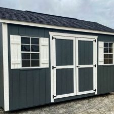 Gray 10x16 Garden Shed Max on open lot on cloudy day