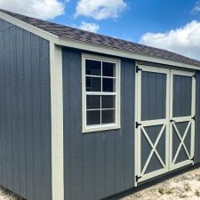 Gray 12x16 Utility shed with silver maple trim and barn-style doors ( with X detail )