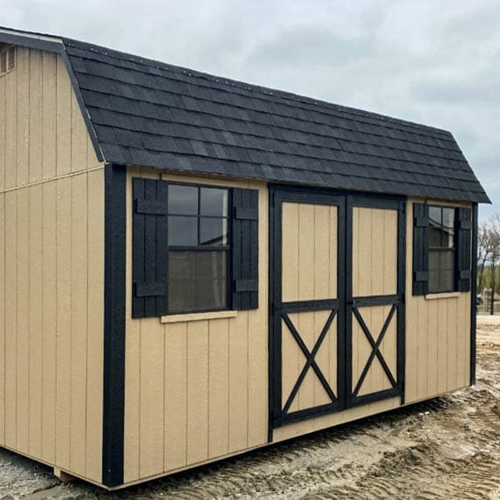 Exterior view of a beige and black 10x16 Garden Shed Max in Bonaire GA with barn-style double doors