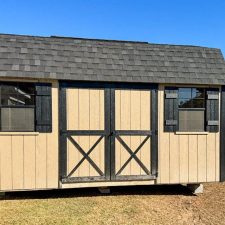 Exterior view of a beige and black 10x16 Garden Shed Max in Bonaire GA with barn-style double doors