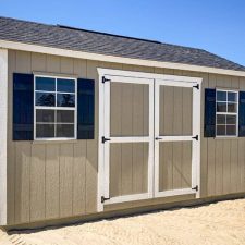 Beige 12x16 Garden Shed Max with white-trimmed double doors and two black-trimmed windows