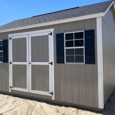 Beige 12x16 Garden Shed Max with white-trimmed double doors and two black-trimmed windows