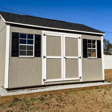 Beige 12x16 Garden Shed Max with white-trimmed double doors and two black-trimmed windows