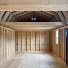 Interior of 12x28 Lofted barn Max with exposed wooden beams