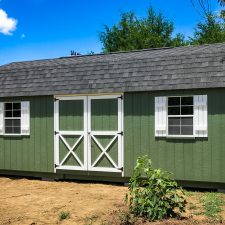 A custom lofted storage shed in Georgia with green painted siding