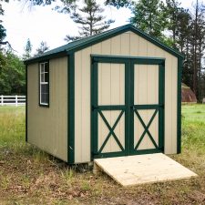 A custom utility storage shed in Georgia with green trim
